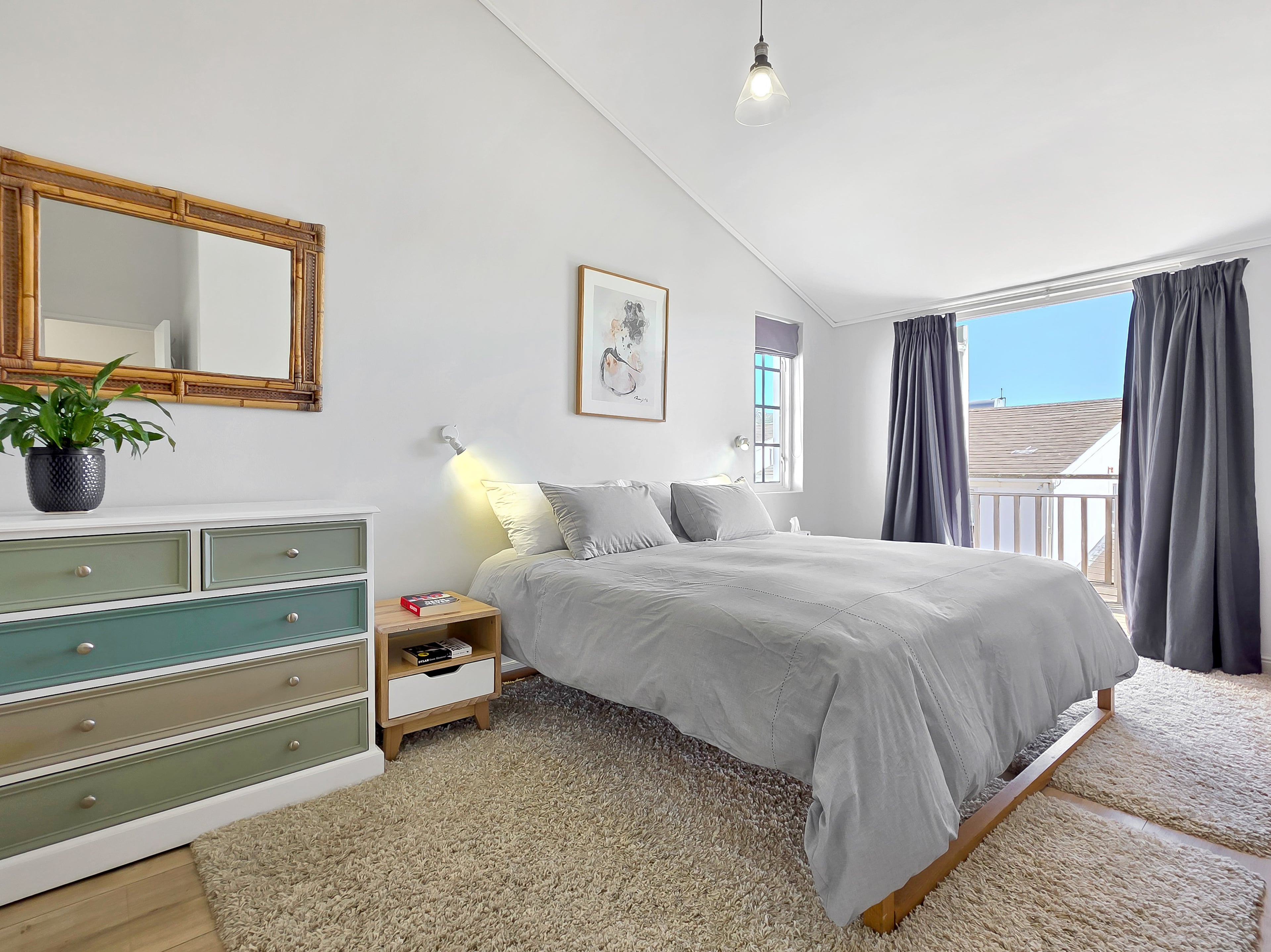 Master bedroom with the balcony overlooking the village and False Bay. 